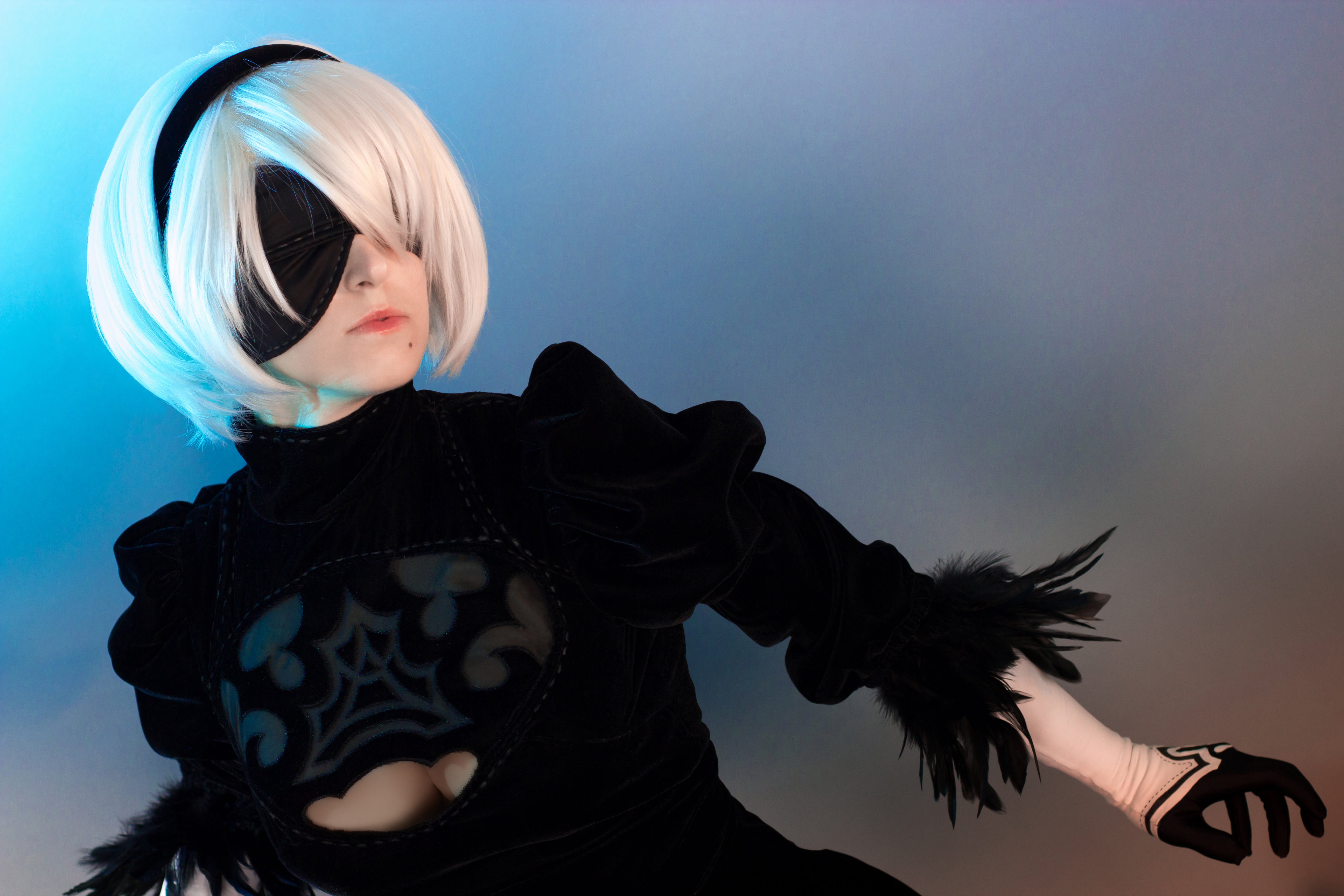 Character with white hair and black outfit against a gradient background