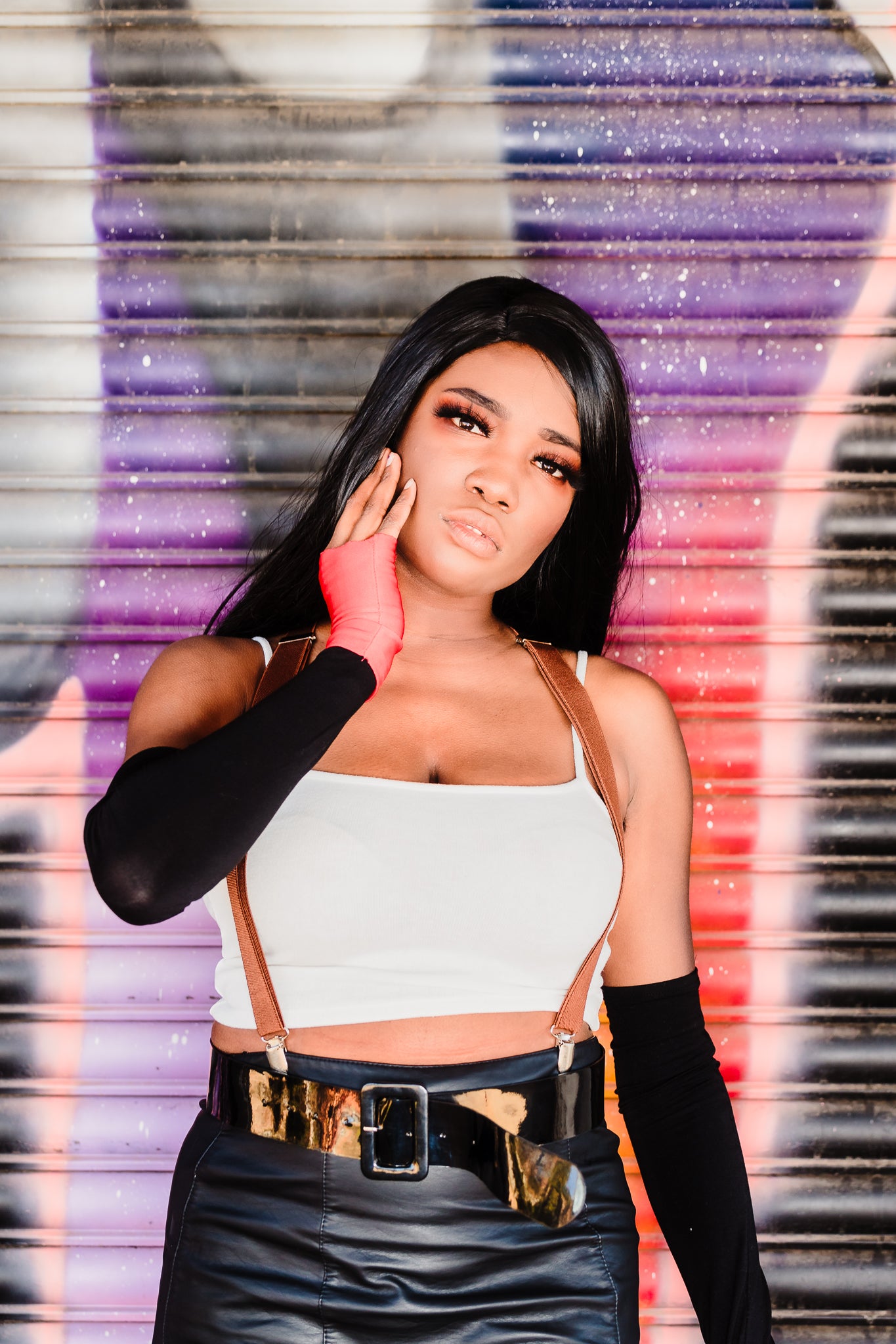 Woman posing in front of a colorful metallic shutter